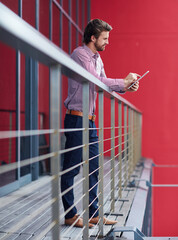 Wall Mural - Business, balcony and man with tablet, typing and internet with connection, social media and online reading. Person, consultant and entrepreneur in modern office, technology and digital app for news