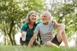 © Maria Vitkovska - Smiling senior couple, mature woman and man relaxing together in the park after exercising