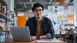 © sungedi - Young Asian Man Working on Laptop in Creative Office