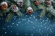© Nataliia_Trushchenko - A blue background with snowflakes and pine cones. The pine cones are in various sizes and are scattered throughout the image