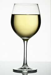 A wine glass filled with white wine.