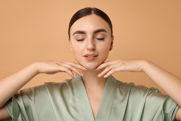 Poster - Face massage. Beautiful young woman with healthy skin on beige background