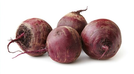 Wall Mural - A group of four fresh beetroots with earthy roots, showcasing their natural appearance.