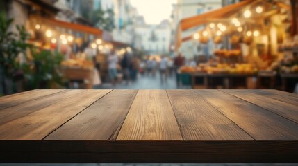 Wall Mural - A wooden table in the foreground with a blurred market scene in the background.