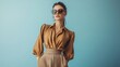 © The Little Hut - Portrait of a stylish fashion model girl posing in a designer brown blouse and wide leg pants Gray background Stylish sunglasses Haute couture collection : Generative AI