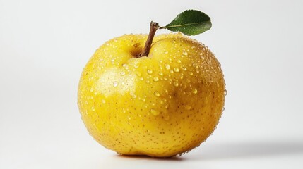 A close-up of a yellow apple with water droplets and a green leaf on a white background.