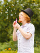 © Voyagerix - Man blowing soap bubbles, having fun