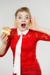 Funny woman holds cream puff cake