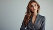 © The Little Hut - Full length portrait of a beautiful female fashion model posing in a grey pantsuit on a white studio background High fashion Futuristic Fashion style : Generative AI