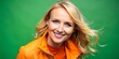© BrilliantPixels - Blond Woman Smiling in Orange Jacket Against Green Background, portrait, woman, green screen