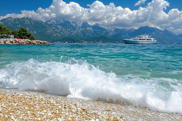 Wall Mural - White Wave Crashing on Pebbles with Mountain and Yacht in Background