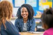 © Gatherina - Elementary school teacher smiling during parent teacher meeting