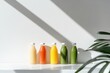 © Boinah - Five colorful juice bottles arranged on a shelf with natural light and shadows.