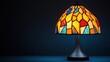 © Creator88 - A stained glass Tiffany lamp isolated with vibrant, colorful illumination spilling onto the surface Tiffany lamp, illumination, ambient stained glass