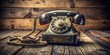 © Four888 - A vintage rotary dial telephone, with a worn cord and faded numbers, sits on a distressed wooden desk,