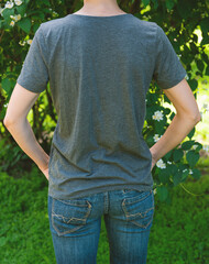 Wall Mural - Woman wears grey t-shirt back view mockup ideal for branding and design