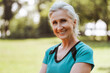 © Maria Vitkovska - Smiling senior woman smiling while relaxing after exercising outdoors