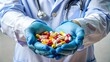 © Diana - A healthcare worker in blue gloves holding a variety of colorful pills, highlighting medical treatment, pharmaceutical products, and healthcare support.