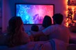 © pavlofox - Family enjoys a movie night together in a cozy living room