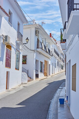 Naklejka na meble Street, mountain and travel with old city, holiday and adventure with vacation, Frigiliana and Andalusia. Spain, empty and buildings with architecture, outdoor and road with journey, sky and holiday