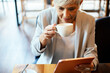 © Davor - Elderly professional woman enjoying coffee in a cafe