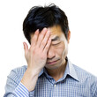 © stockpro - An Asian man expressing frustration and stress, covering his face with one hand. Isolated on a transparent or white background.