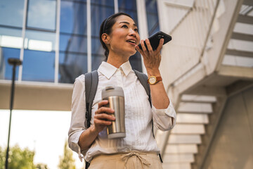 Wall Mural - Mature japanese business woman record voice mail on mobile phone