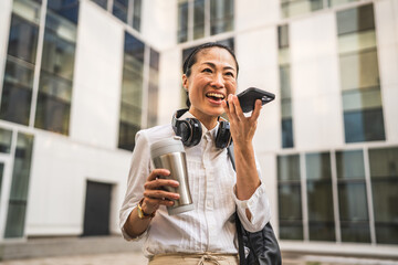 Wall Mural - Mature japanese business woman record voice mail on mobile phone