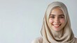 © Alien - Portrait of young smiling muslim woman wearing a white hijab over white background studio