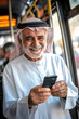 © AI_images_for_people - A senior Arabian man, smiling warmly as he uses his mobile phone to pay for bus fare, standing confidently near the bus driver. .jpg