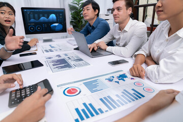 Wall Mural - Analyst team utilizing BI Fintech to analyze financial data at table in meeting room. Businesspeople analyzing BI dashboard power for business insight and strategic marketing planning. Prudent