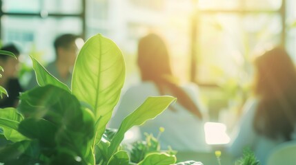 Canvas Print - A bright green plant in focus, with people blurred in the background, giving a fresh and serene feel to a casual gathering.