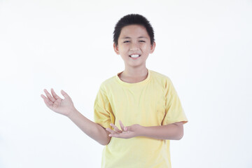 Happy asian boy pointing fingers aside at copy space isolated over white background