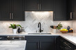 © Aleena - Modern kitchen with black cabinets, white marble countertop and silver sink in front of wall made from chevron pattern tiles. Minimalist interior design