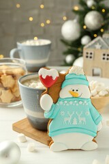 Sticker - Delicious cookie in shape of snowman, cup with cocoa and Christmas decor on white wooden table