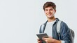 © Maria Mikhaylichenko - Confident young student with backpack smiles while holding tablet, embodying modern education and technology integration in campus life.