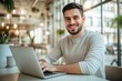 © kitipol - High-resolution brightly lit photorealistic candid photograph of a young marketer working on his laptop in a modern, light-filled office with a contented expression. The photograph is styled like a