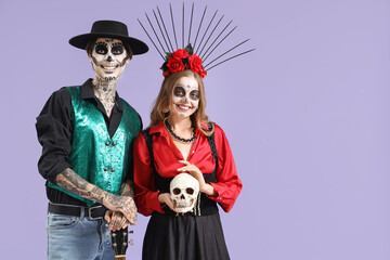 Wall Mural - Young happy couple dressed for Mexico's Day of the Dead (El Dia de Muertos) guitar and painted skull on purple background