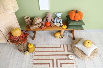 Poster - Interior of children's room with wooden bench, folding screen and pumpkins