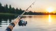 © Iswanto - A fishing rod rests by a serene lake at sunset, capturing a moment of leisure and nature.