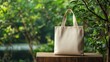 © B 7 YOU - White tote bag on wooden table with blurred green background.