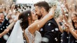© MarkFinal - groom lifting the bride into the air for a kiss, surrounded by a shower of confetti, with beaming guests cheering them on