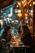 © fanjianhua - In the evening, two young women were having a dinner on the street