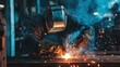 © B 7 YOU - A welder in a welding mask and gloves works on a metal project, sparks flying.