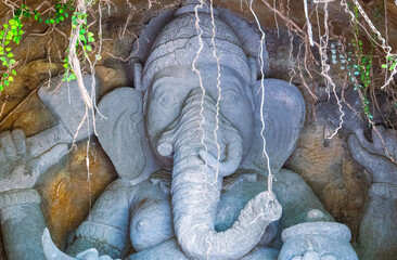 Ganesha Statue seated on a human skull Carved from volcanic rock located in Bali Safari Marine Park, Bali, Indonesia