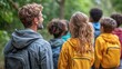 © Рудой Максим - A group of children and an adult exploring a forest path on a sunny day surrounded by lush greenery