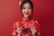 © fanjianhua - Chinese New Year, a young woman holding a red envelope