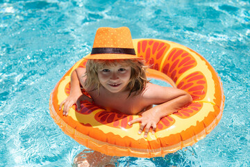 Wall Mural - Child playing in swimming pool. Summer vacation concept. Summer kids portrait in sea water on beach.