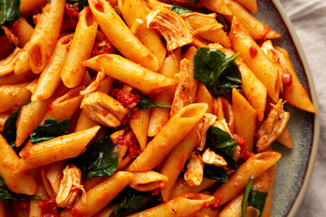 Wall Mural - Homemade One-Pot Spinach And Tomato Pasta on a Plate, top view. Close-up.