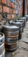 Retro Beer Kegs: Vintage Aluminum Barrels Against Grunge Brick Background in Liverpool, UK